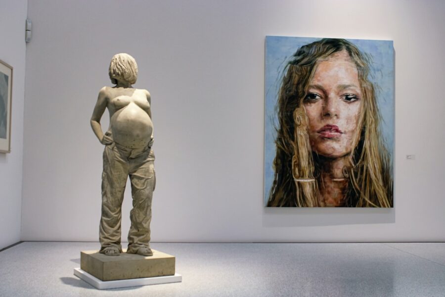 naked pregnant woman statue and woman's portrait