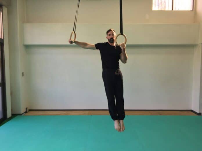 a man hanging upside down on a rope