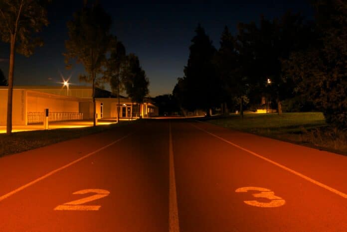 brown and white house near green grass field during night time